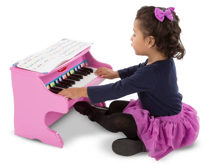 Girl playing a pink piano