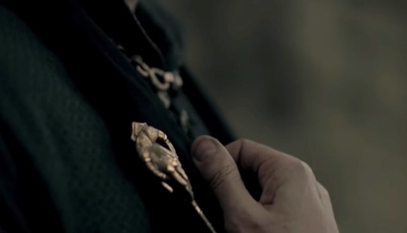 Close-up of the hand of the king pin on someone&#x27;s clothing