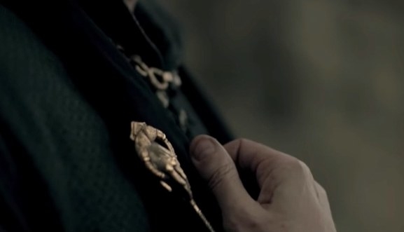 Close-up of the hand of the king pin on someone's clothing