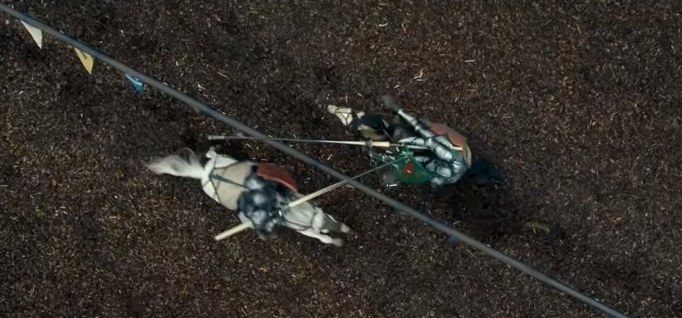 Aerial view of two knights on horseback jousting