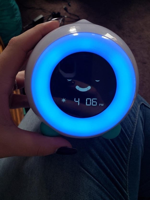 a reviewer photo of the clock and the digital face has their eyes closed like bed time