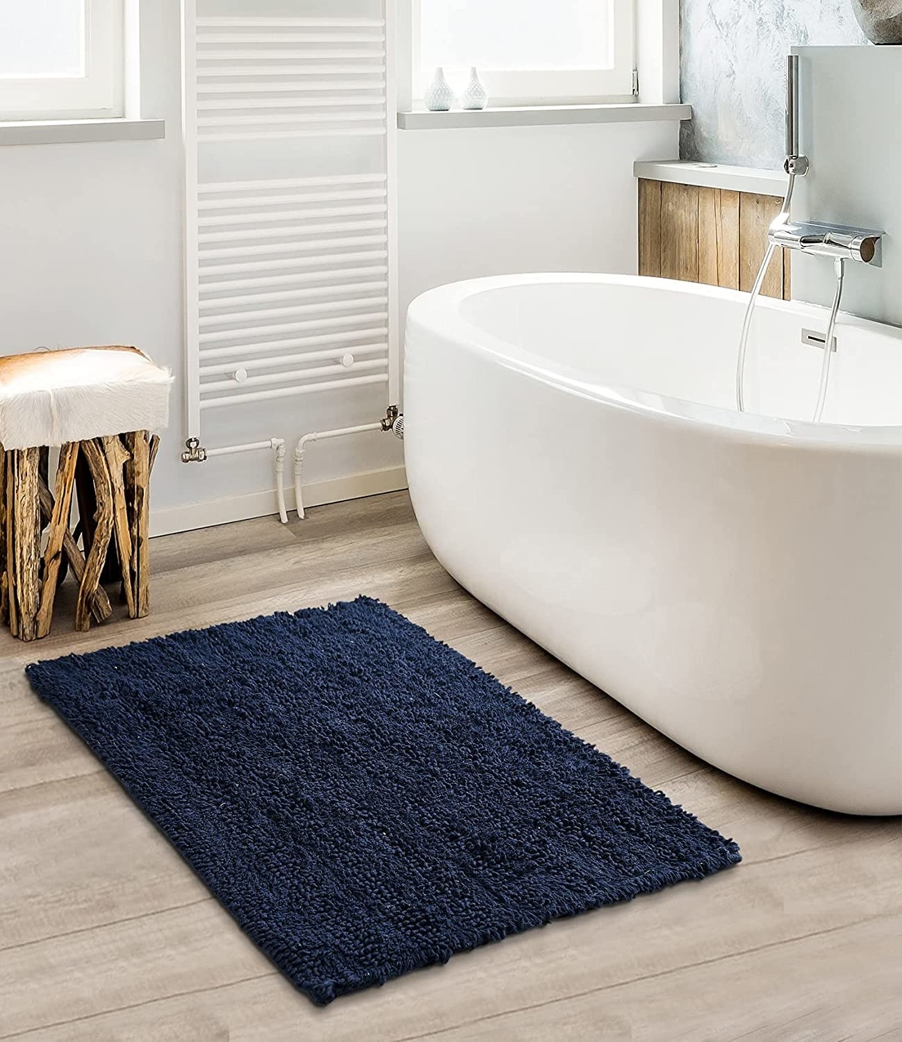 A blue bath mat near a tub