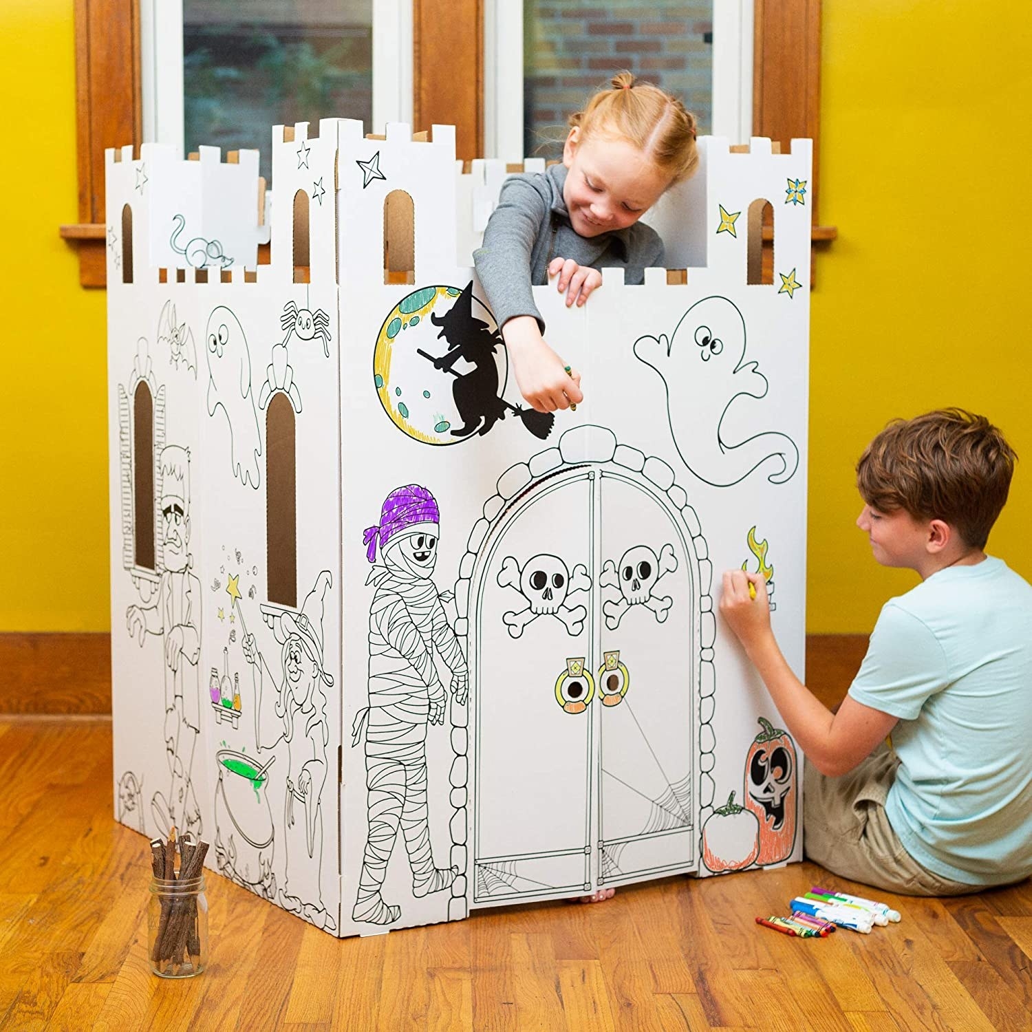 Models coloring the cardboard haunted castle