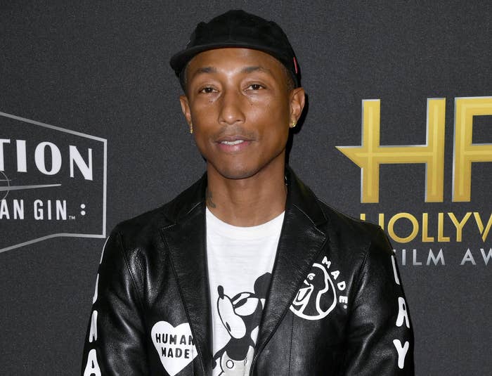 Pharrell in leather jacket and Mickey Mouse T-shirt on the red carpet