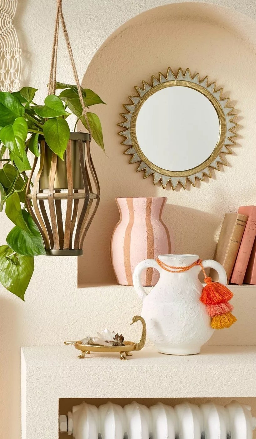 The white vase with two handles on a mantel
