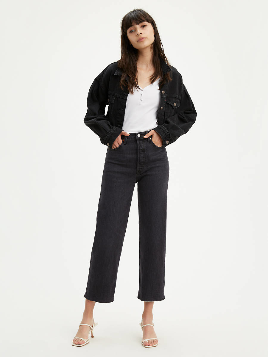 model in straight-leg black jeans