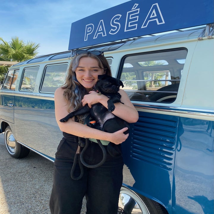 Syd and Phoebe standing in front of a Volkswagen van with a Paséa sign on it