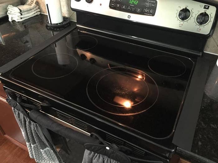 reviewer image of a stove with two of the gap fillers on each side covering the gap between the stove and the counter