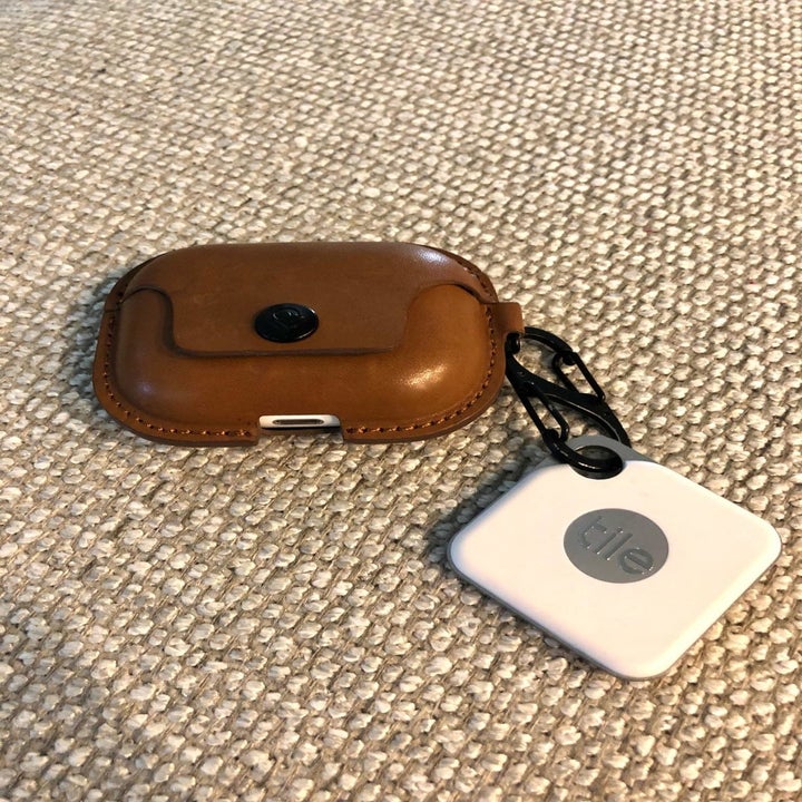 reviewer image of the tile tracker attached to a brown airpods case