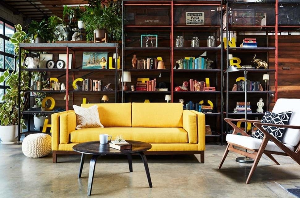 bright yellow sofa with cushioned armrests between the padded frame and seat cushion