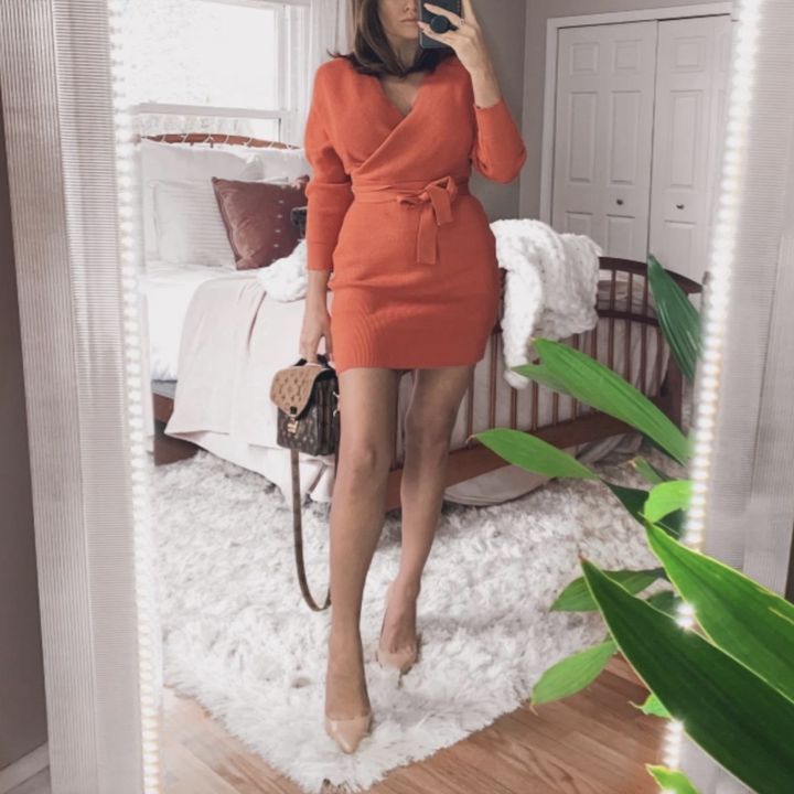 A customer review photo of them wearing the dress in orange