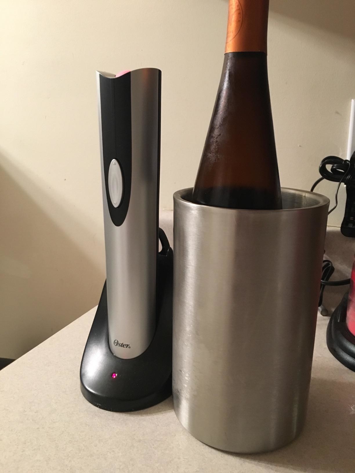 reviewer image of a bottle of wine in the chiller next to the electric wine opener in its rechargeable port