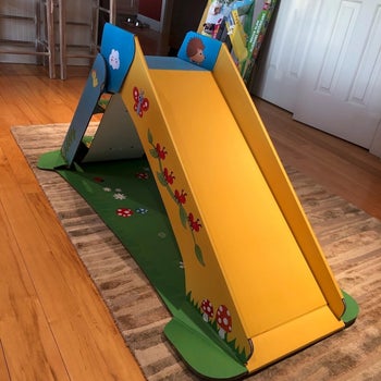 a review photo of the slide in a green yellow and blue color with animals and plants