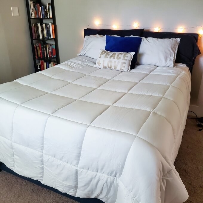 A reviewer&#x27;s photo of the white comforter