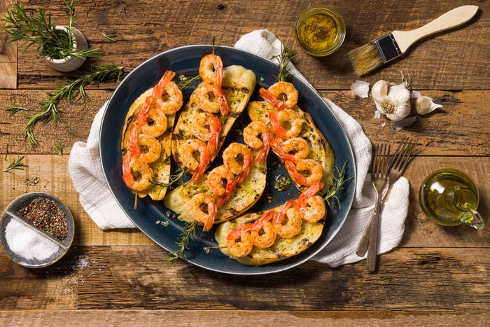 platter with grilled shrimp skewers on toasted bread