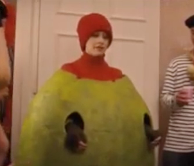 Georgia in stuffed olive costume and red beanie