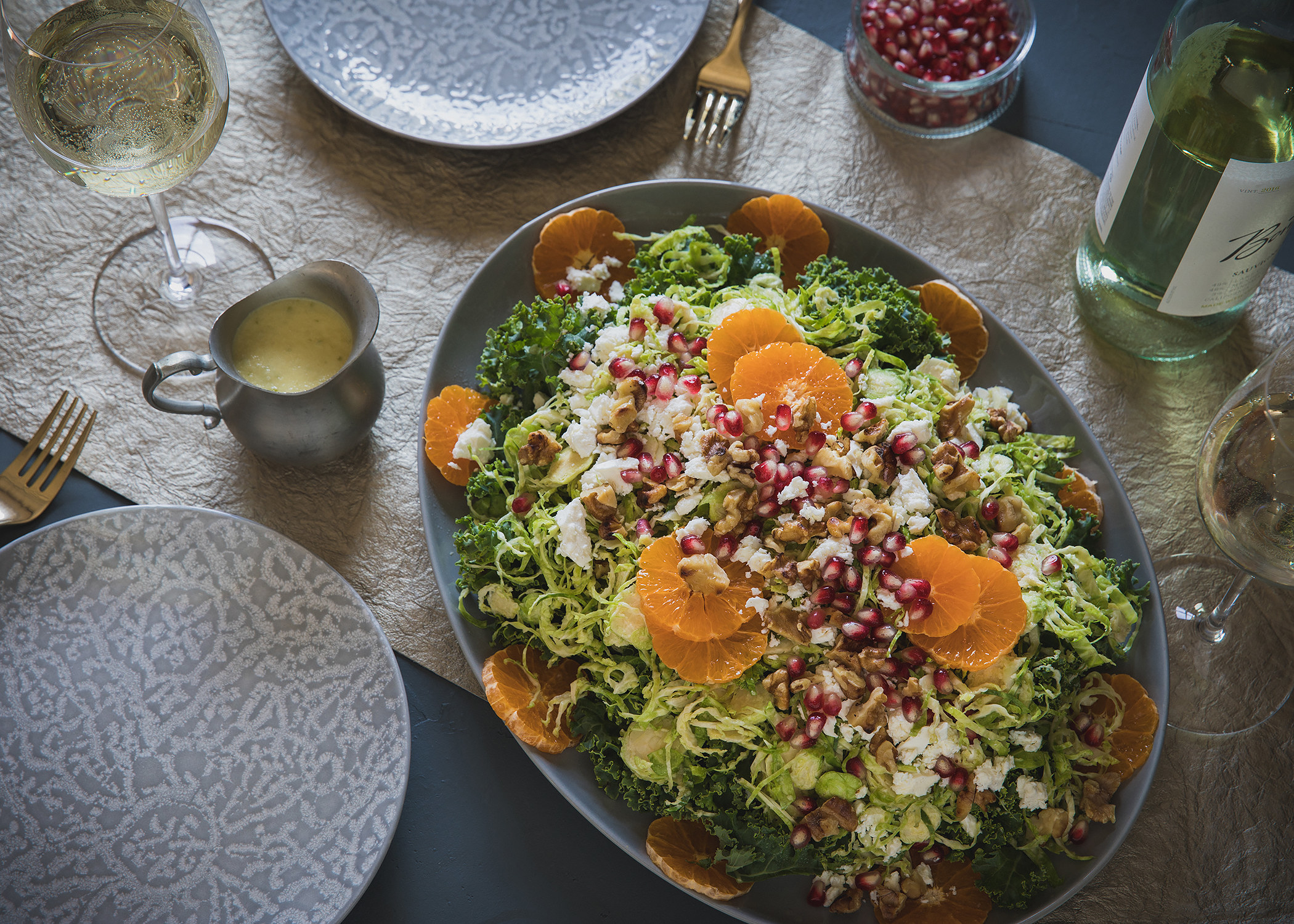 big serving bowl of winter salad topped with mandarin slices