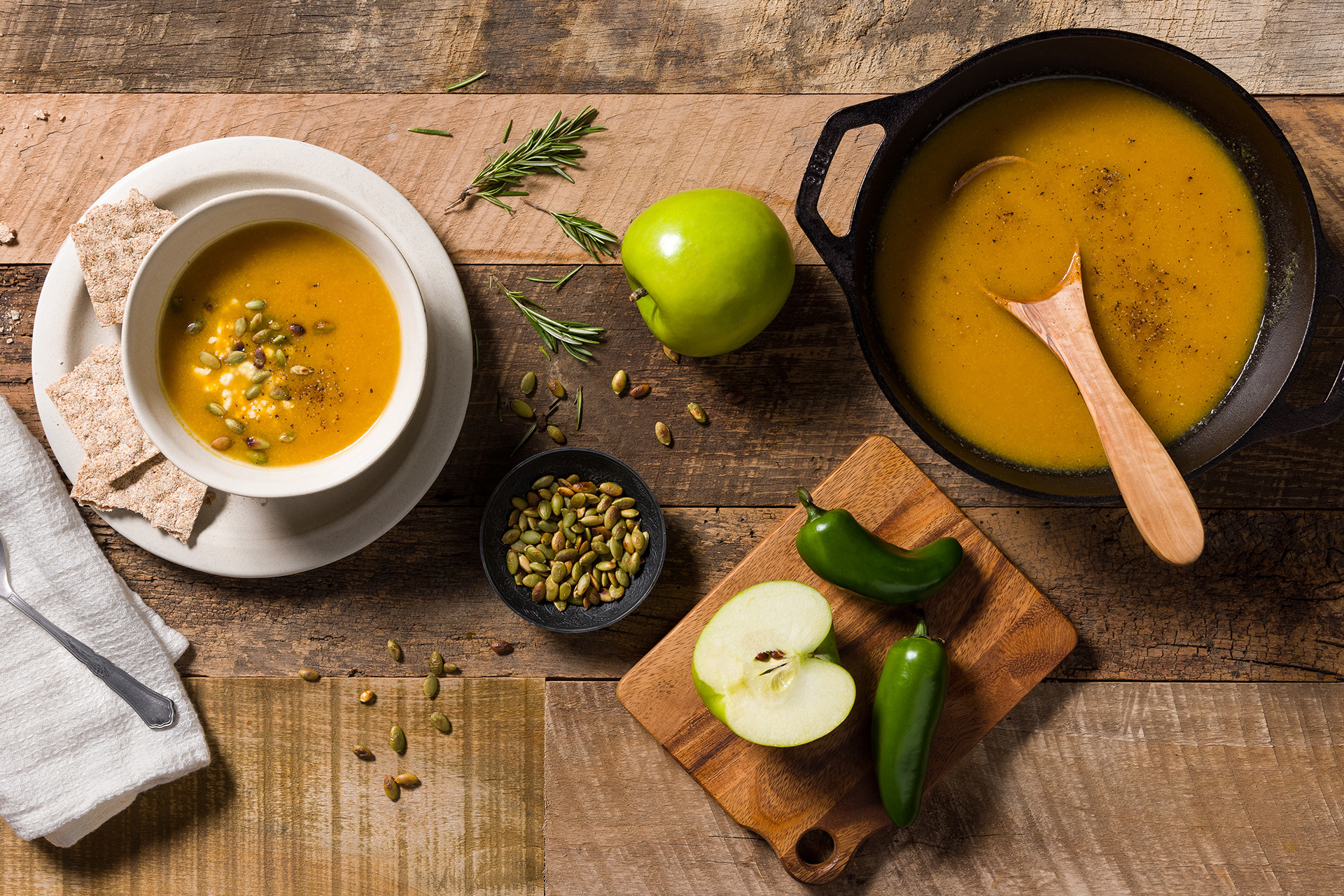 pot and serving bowl filled with pumpkin and apple soup