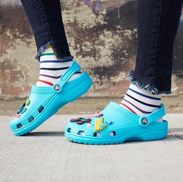 person wearing blue crocs with socks