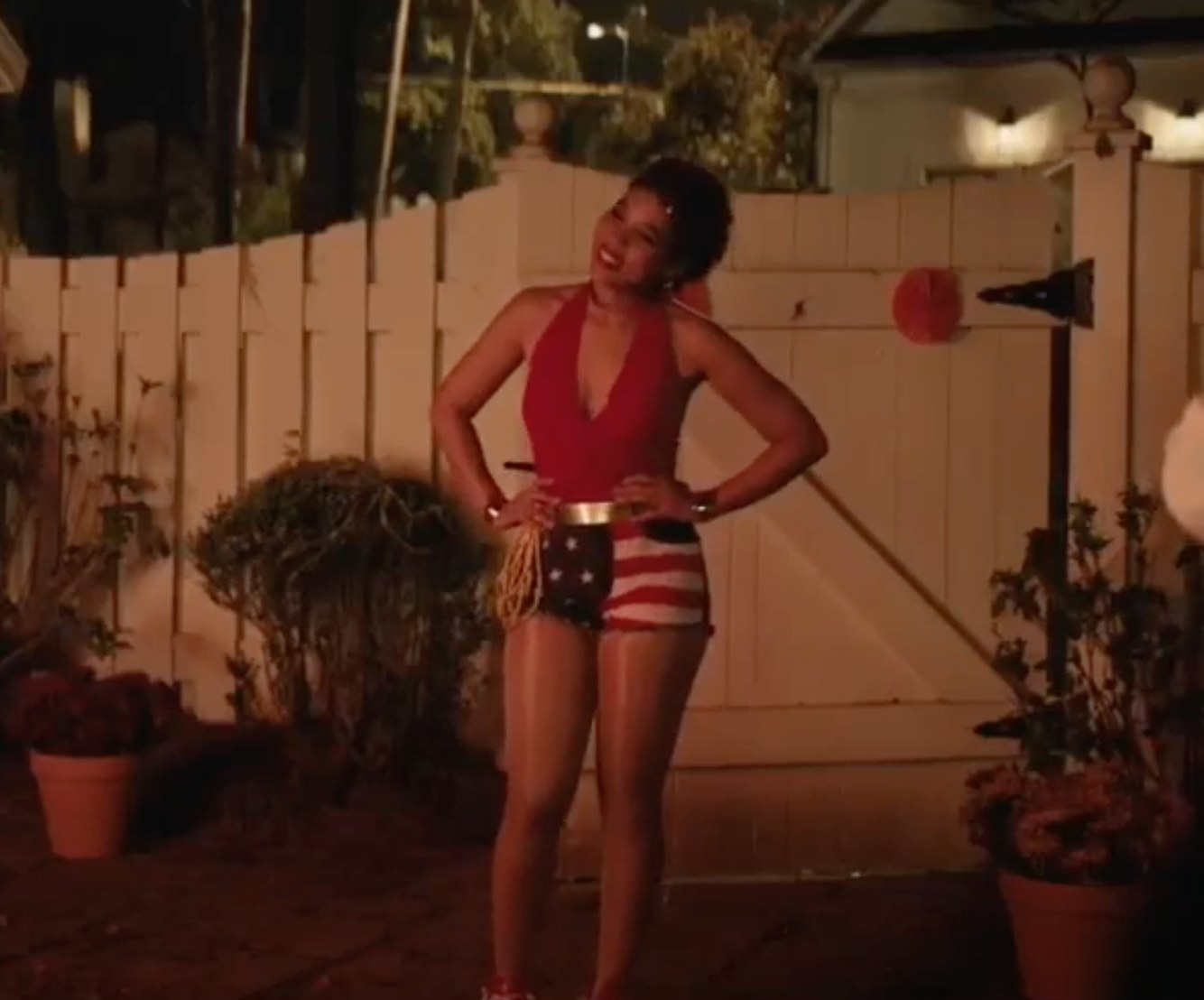 Abby in red top, american flag shorts, and wonder woman accessories