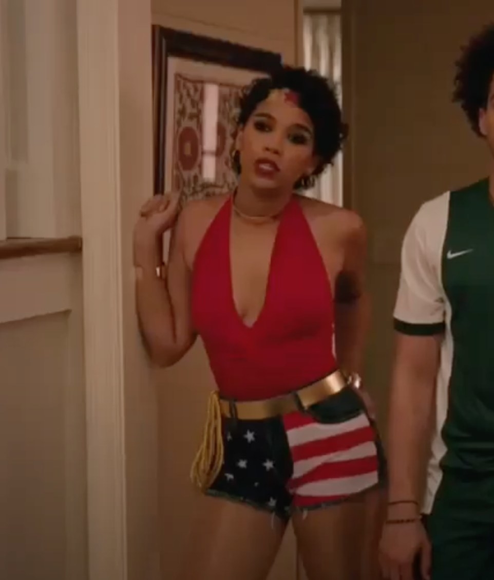 Abby in red top, american flag shorts, and wonder woman accessories