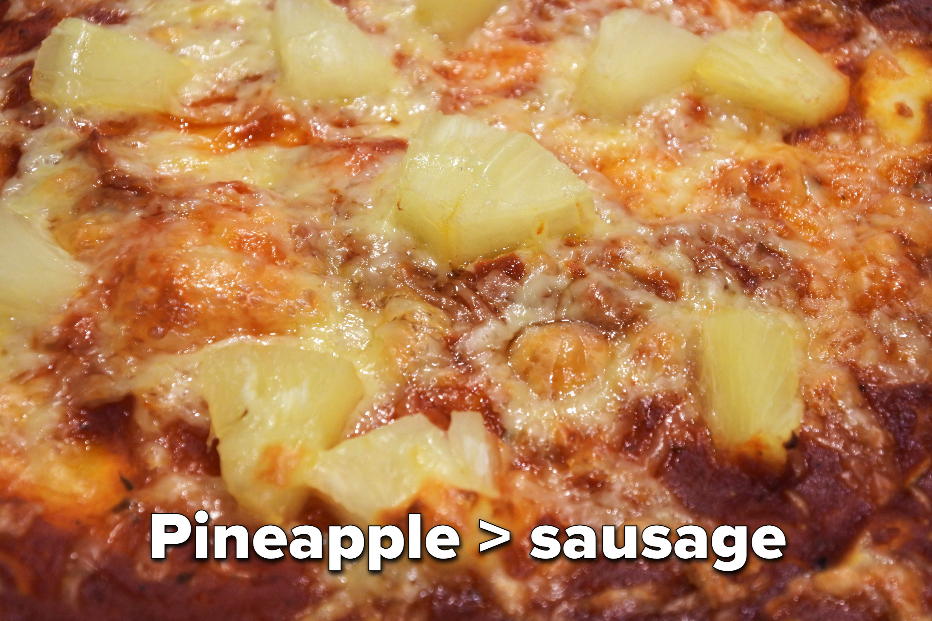 Cut-up pineapple on cheese pizza