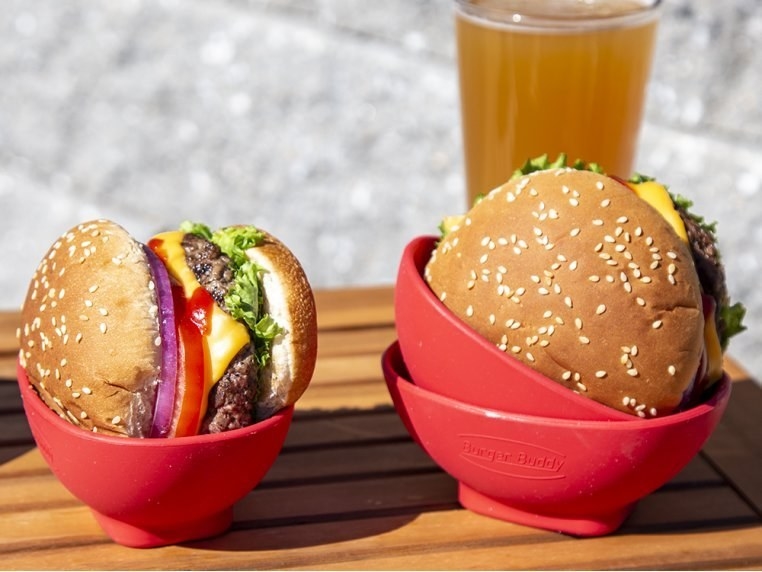 two hamburgers that are placed in the silicone holders