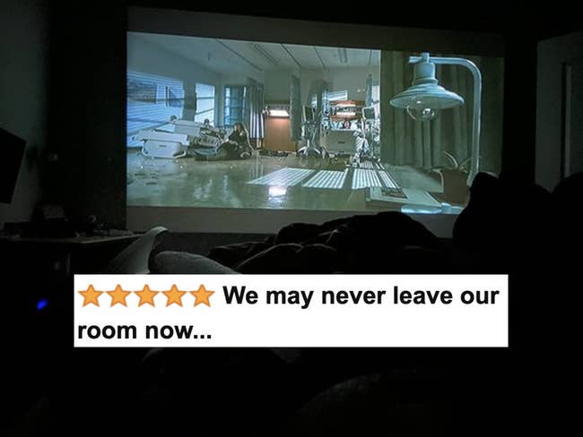 Reviewer's picture of their projector showing a movie across their bedroom wall