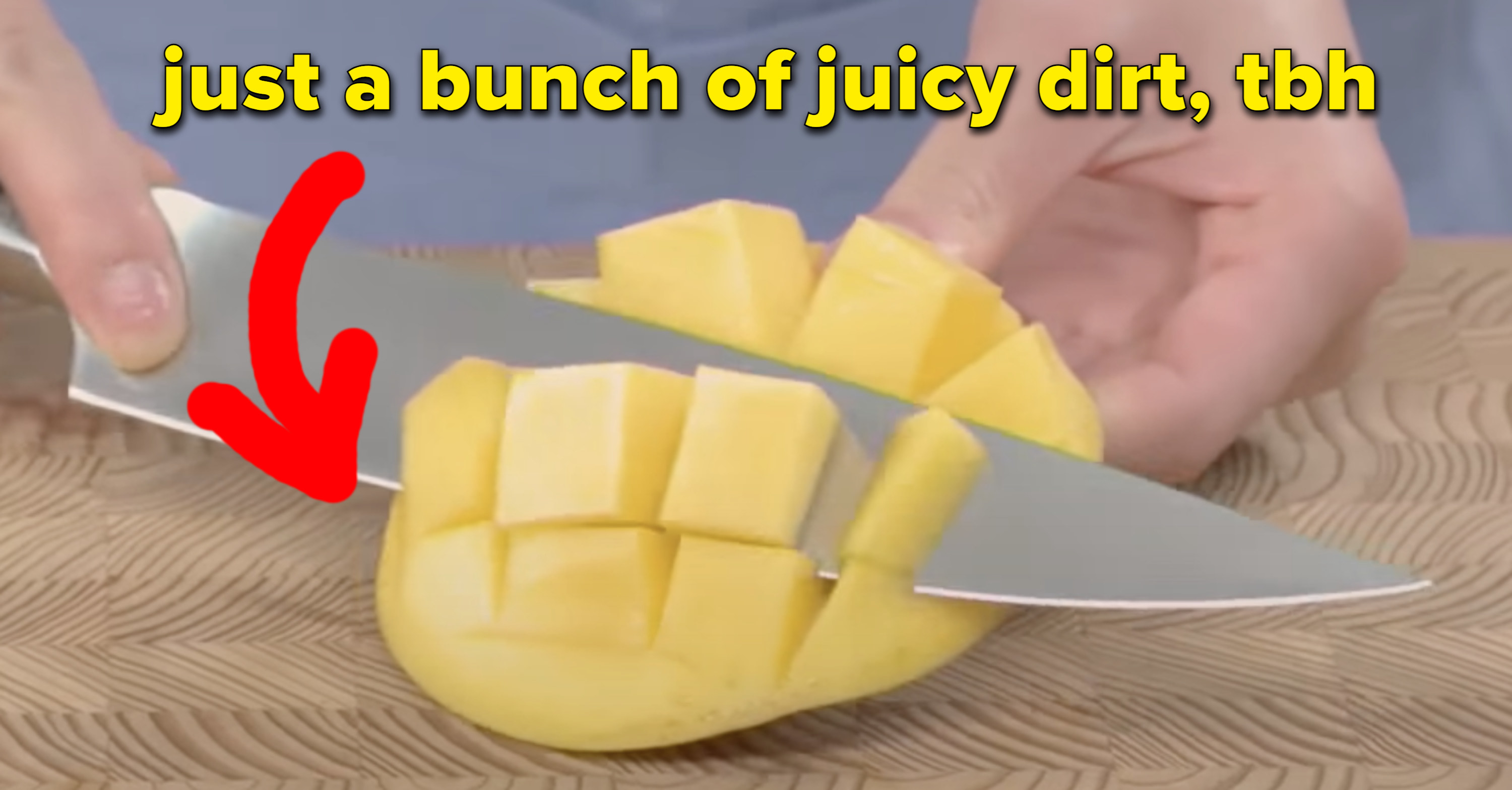 Someone cutting into a mango