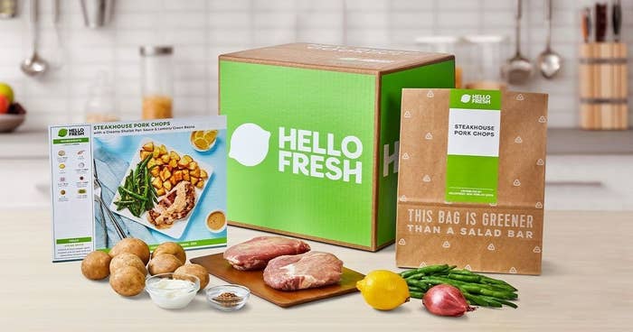 A HelloFresh box with ingredients and recipe instructions laid out on the counter.