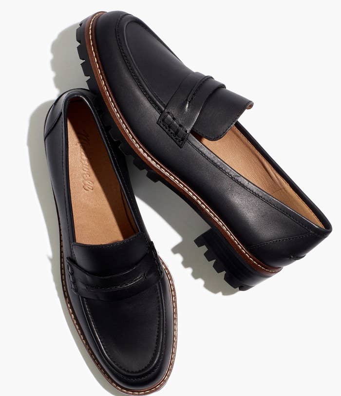 a pair of black leather penny loafers with traction in the sole