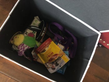 Top down view of the box, which is holding treat bags and toys