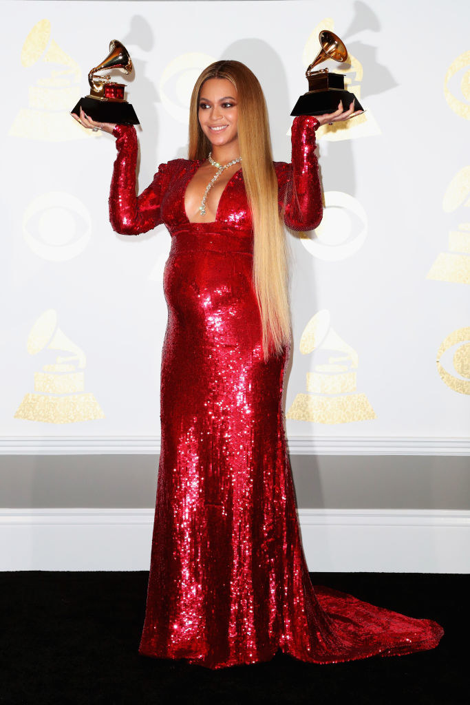 Beyoncé holding two Grammys backstage