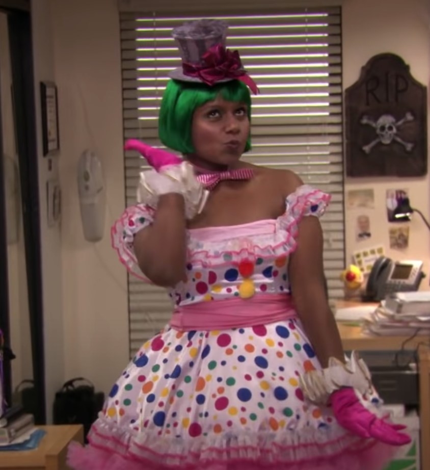 Kelly wearing green wig, clown polka dot dress, and mini hat
