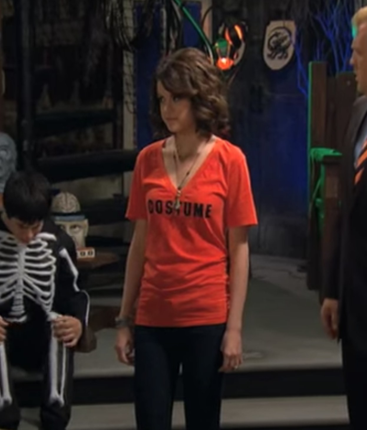 Alex in orange shirt that says &quot;costume&quot;