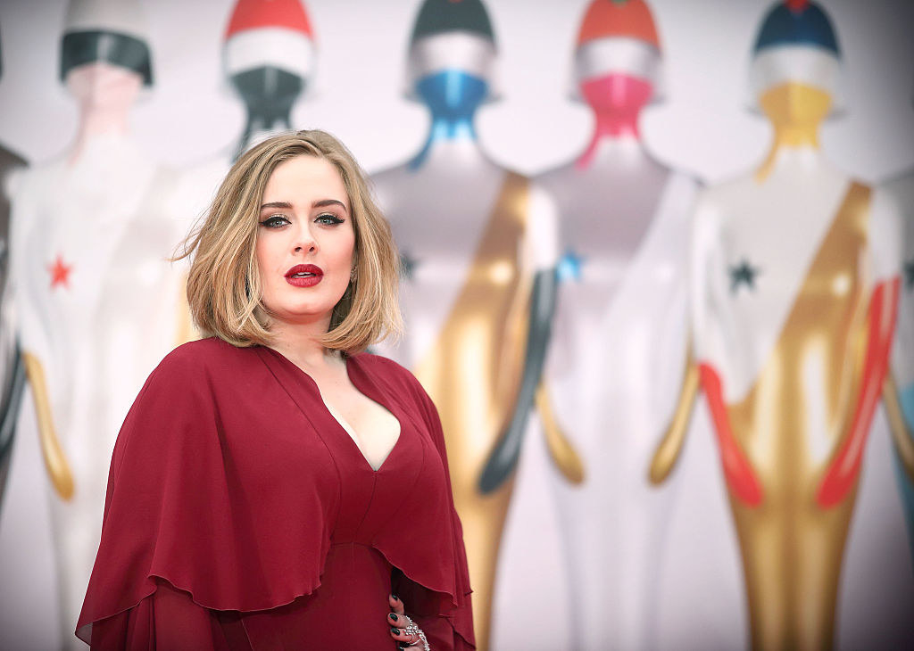 Adele attends the BRIT Awards 2016 in a v-cut gown
