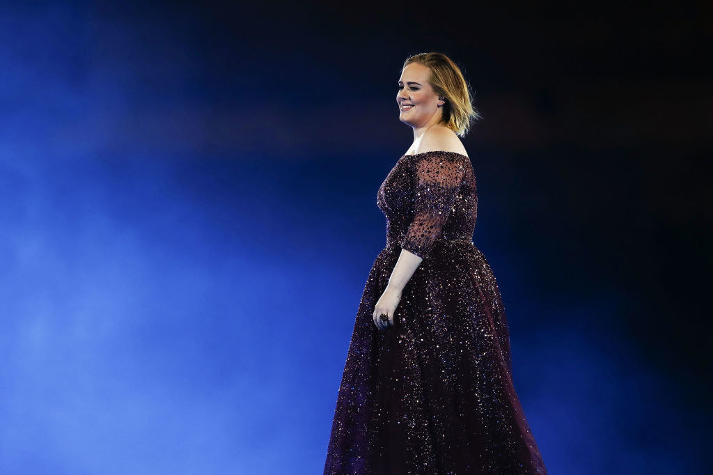 Adele performs at ANZ Stadium in a shimmery off-the-shoulder dress