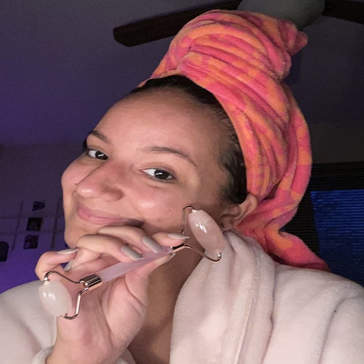 A reviewer using the Jade Roller on their cheek