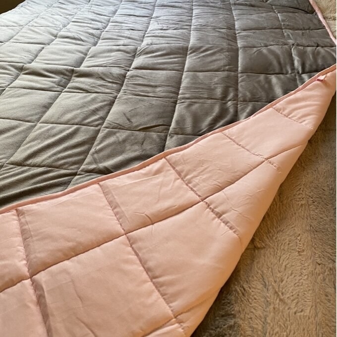 Reviewer&#x27;s photo of the pink and grey reversible blanket