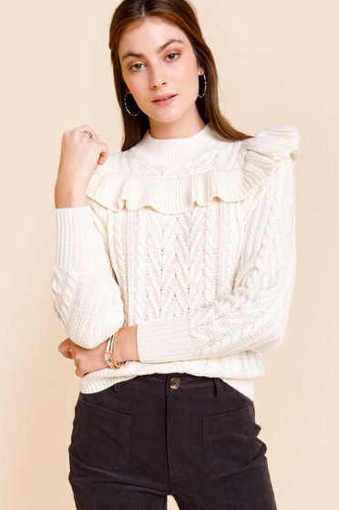 model in cream ruffled sweater