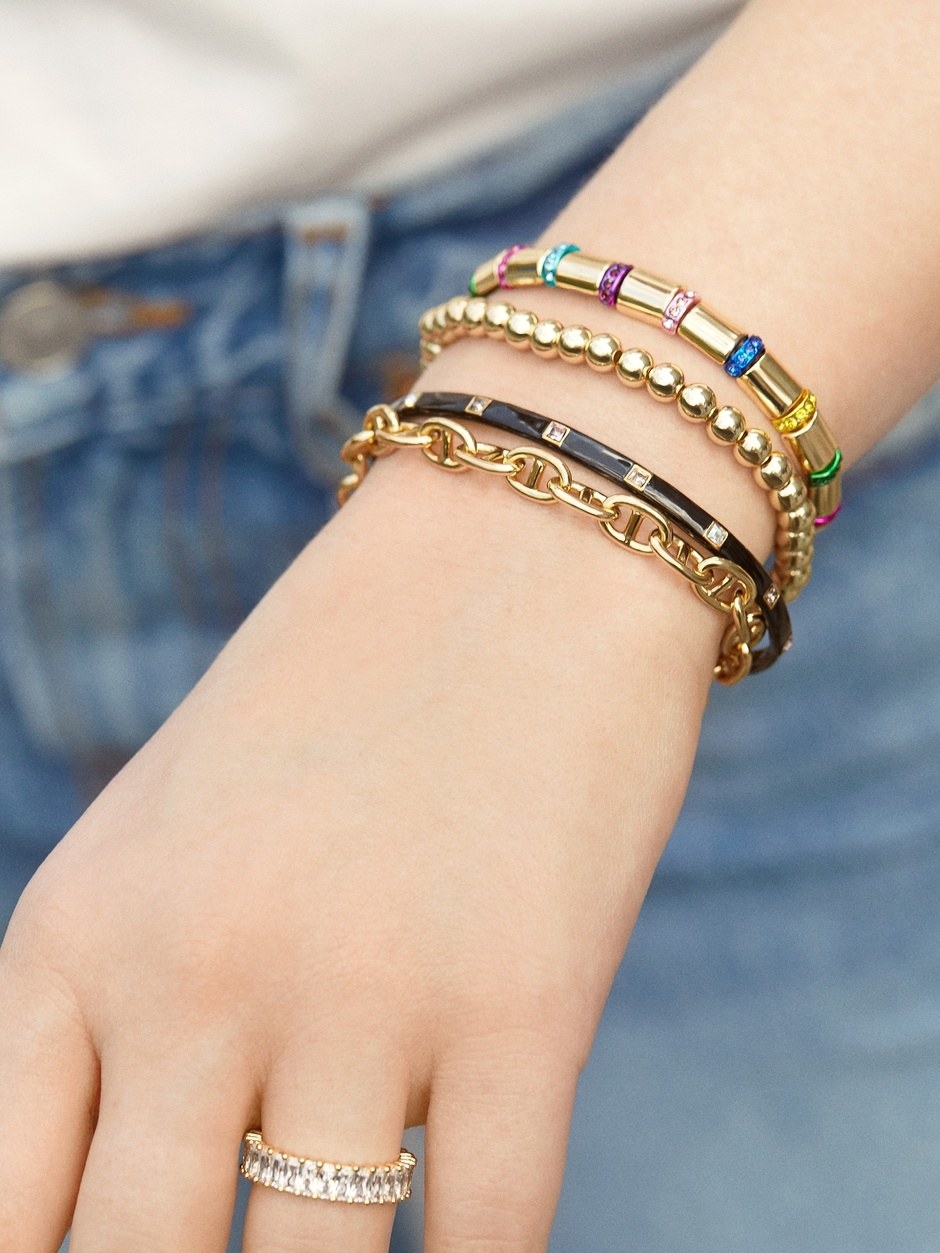 model wearing a stack of bracelets
