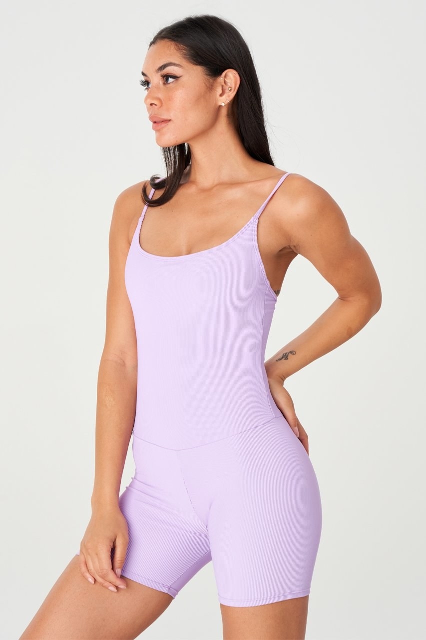 model in lilac cami and bike shorts one piece