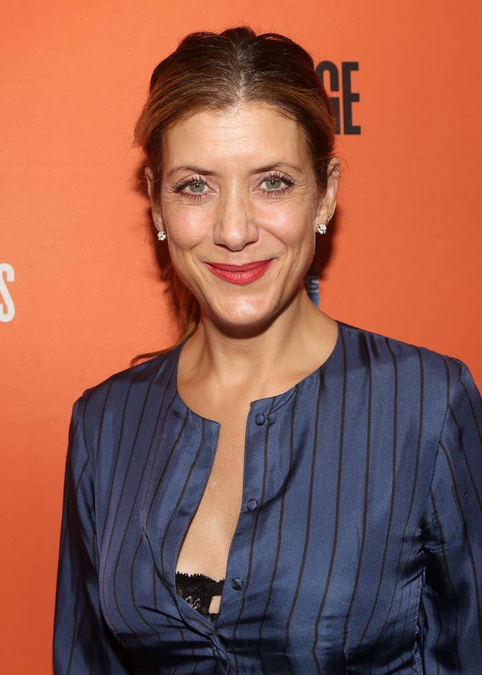Kate Walsh on the red carpet with a partly unbuttoned top showing a hint of a black lace bra