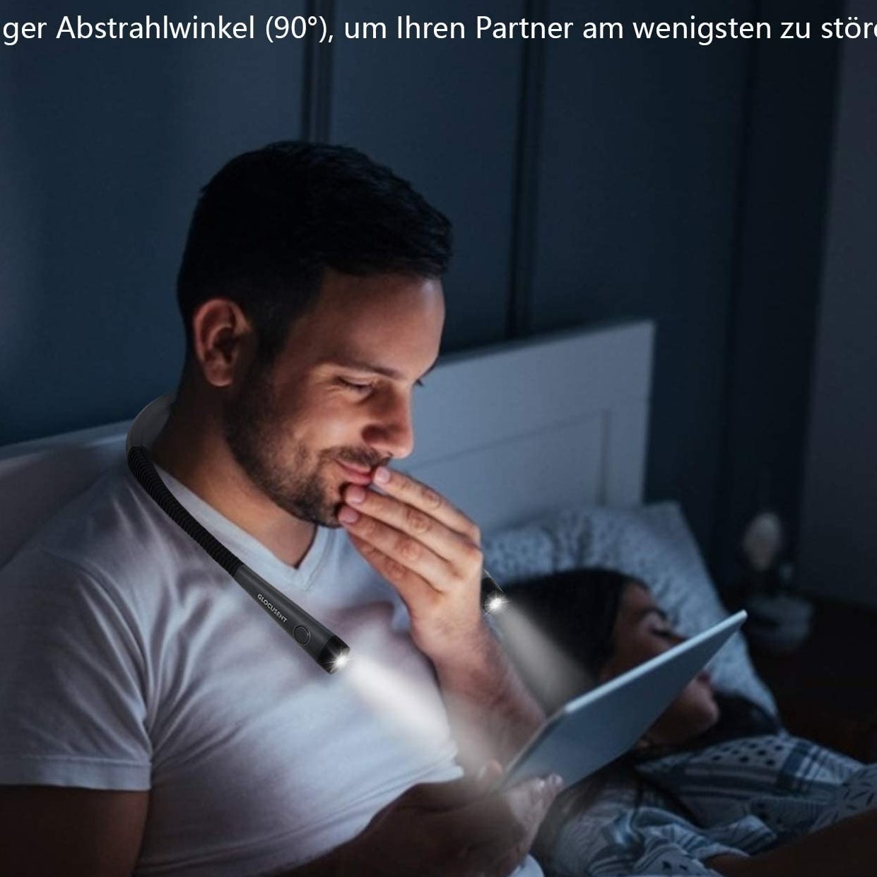 a person reading a tablet in bed while wearing the neck light