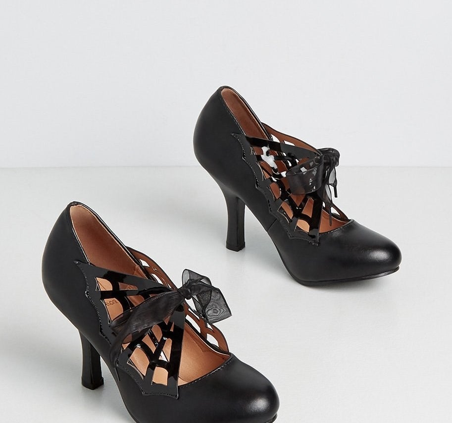 A pair of heels with bows on the front