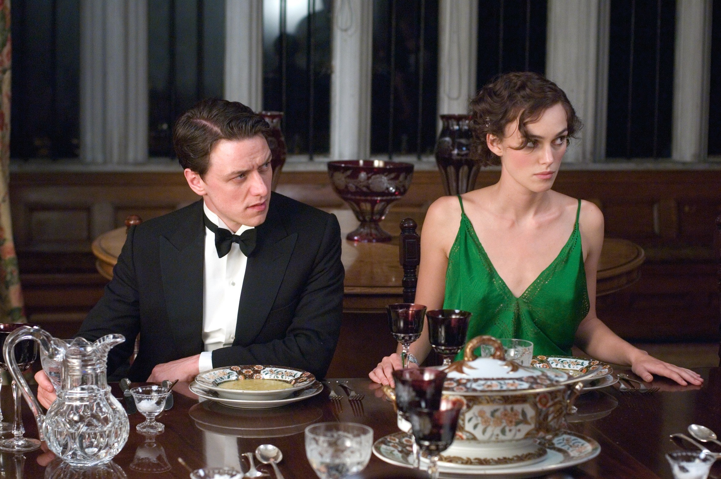James McAvoy and Keira Knightley sit at a dinner table