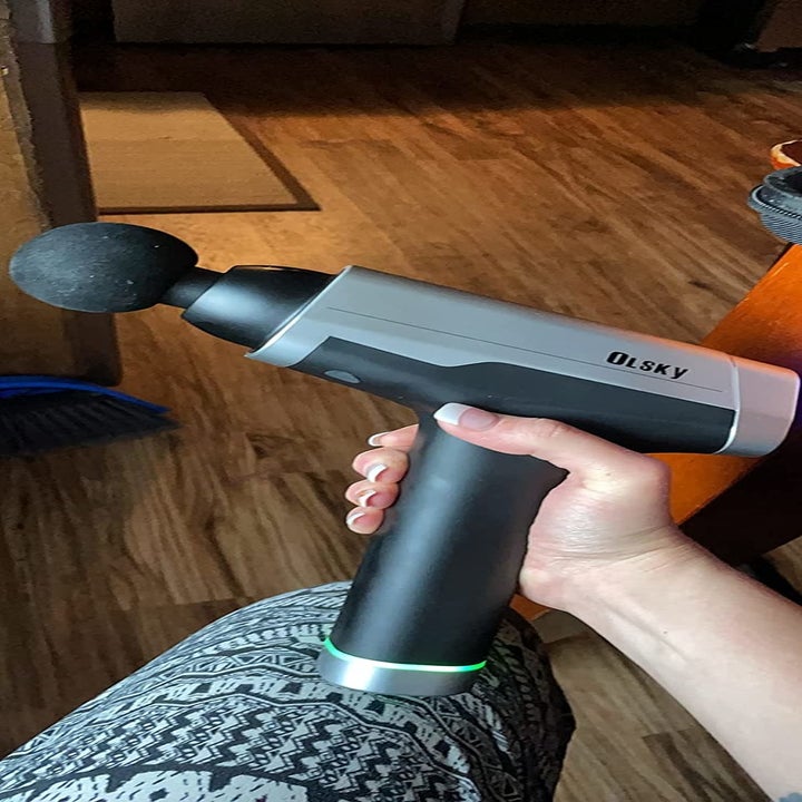 Reviewer holding the massage gun