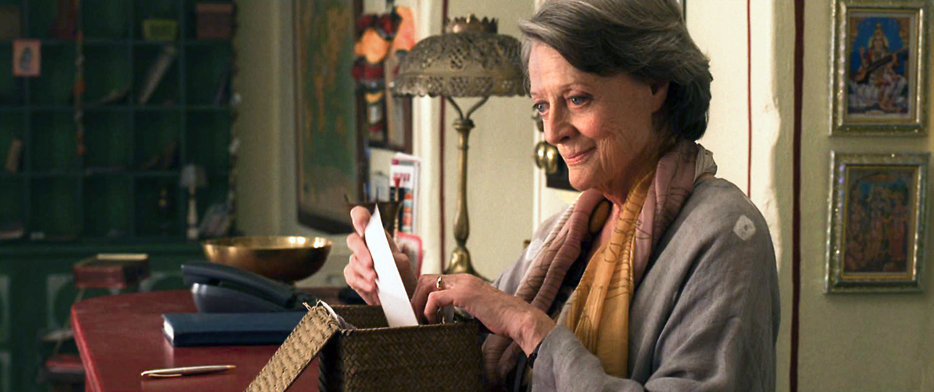 Maggie Smith puts a letter in a box