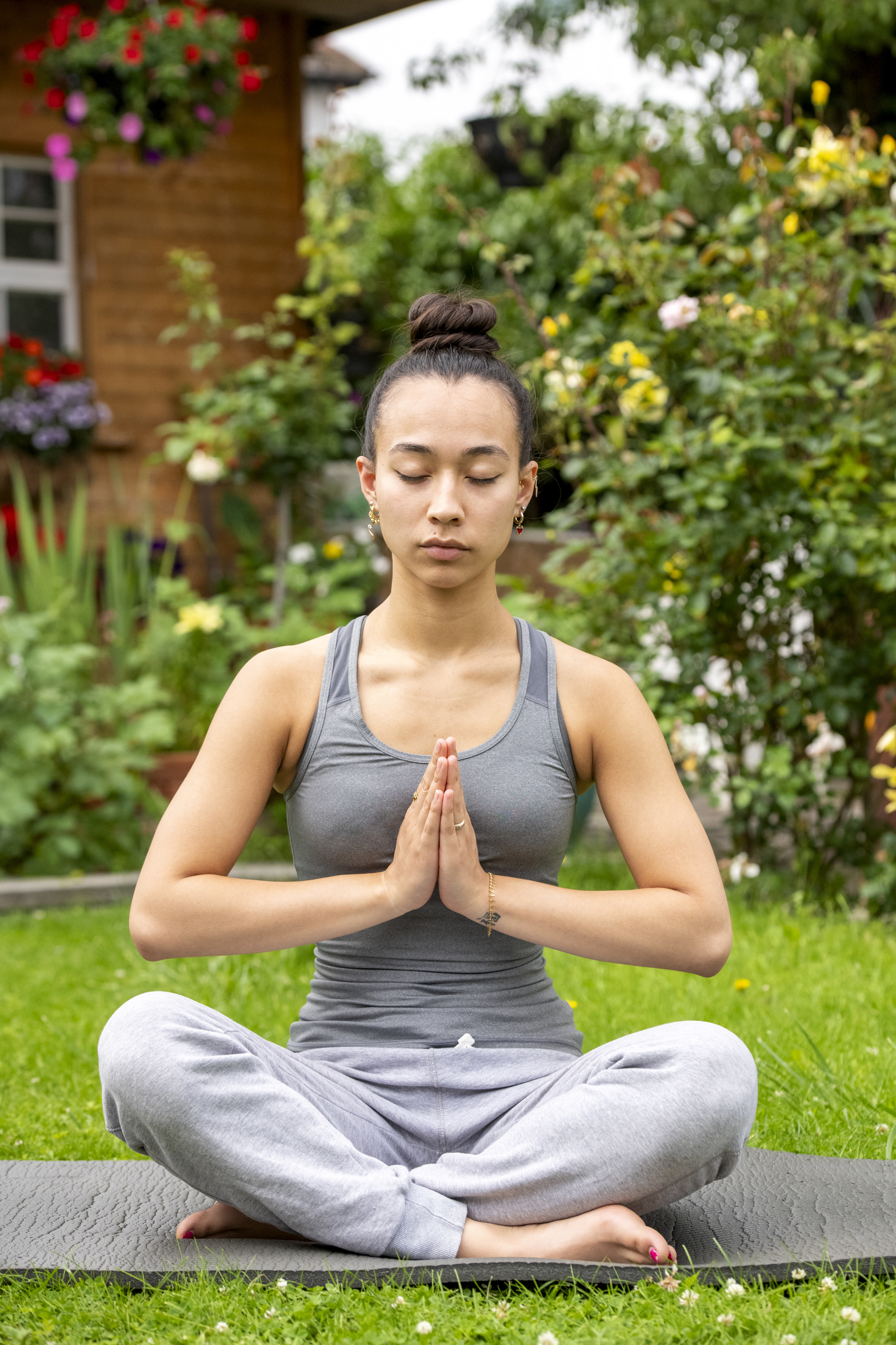 Woman meditating in her backyard