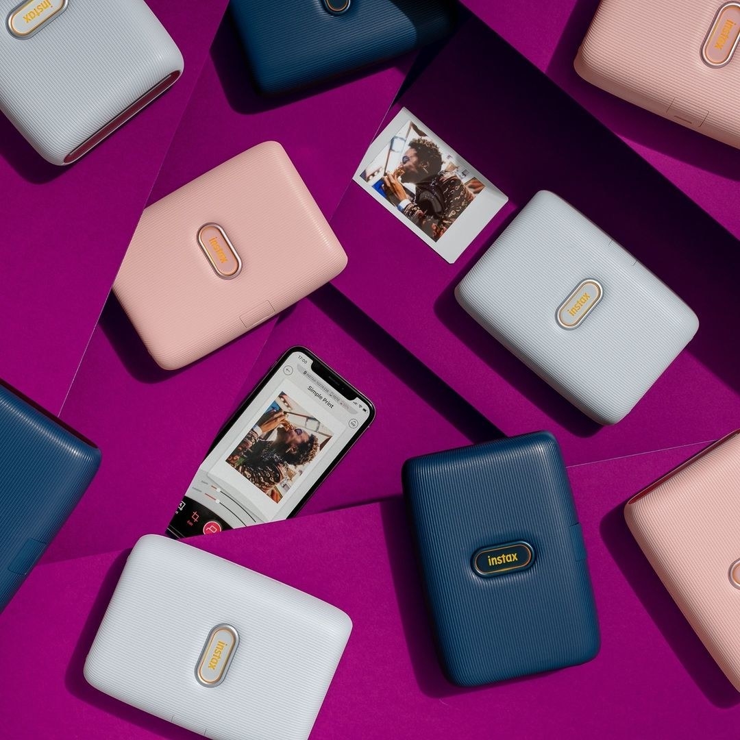 a flatlay of the slim smartphone printers on a colourful background